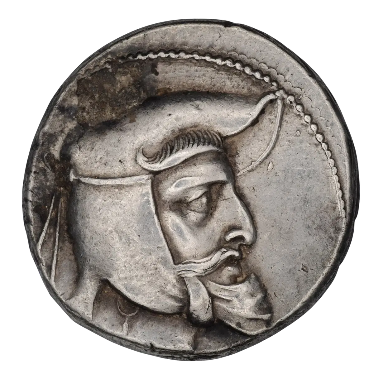 Ancient silver coin with a right-facing helmeted portrait